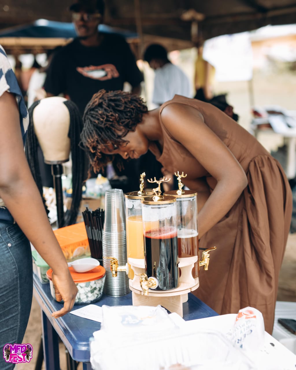 A vendor pouring drinks at a stall